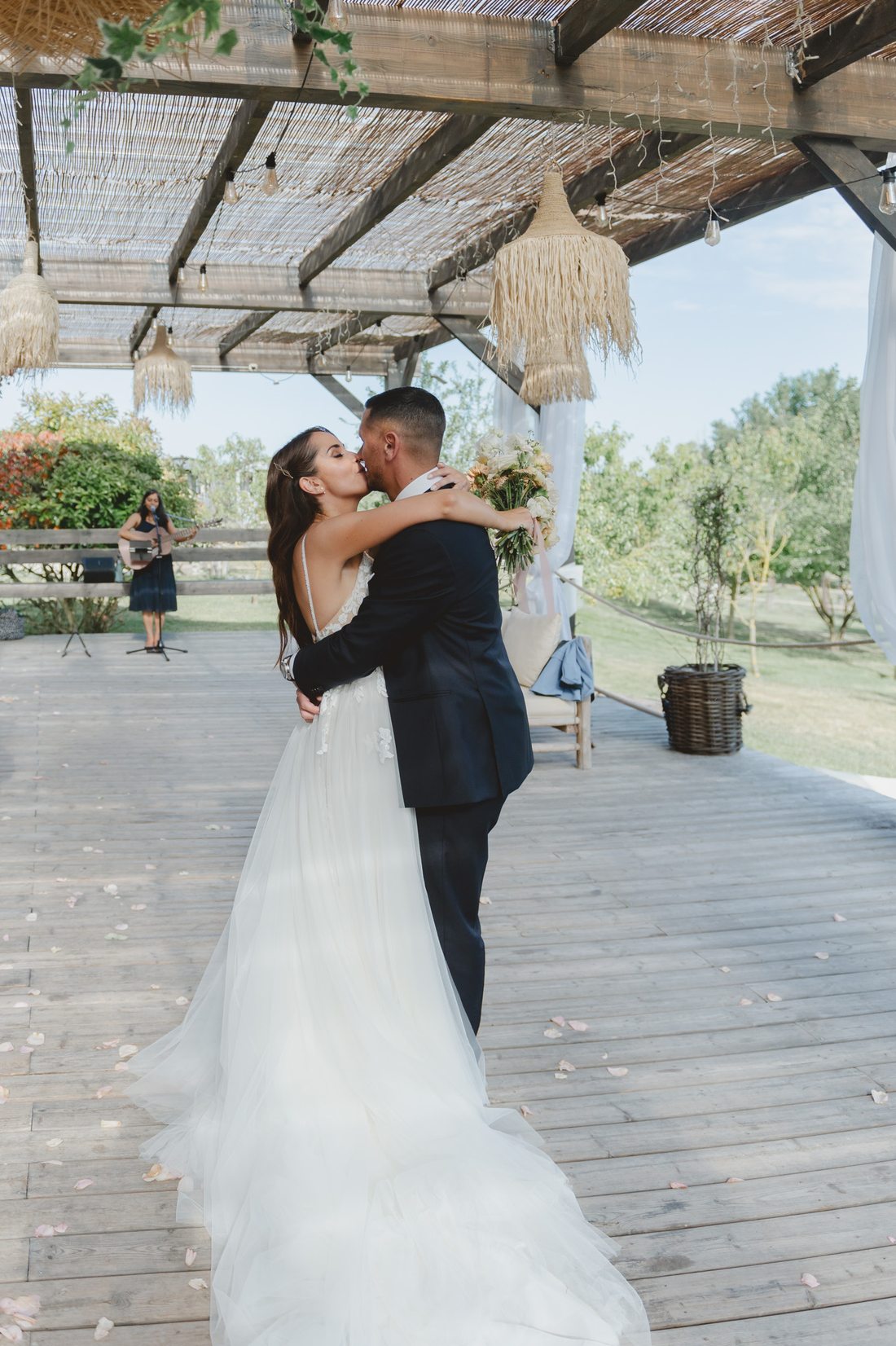The couple kissing after their vows, Sumana singing behind them